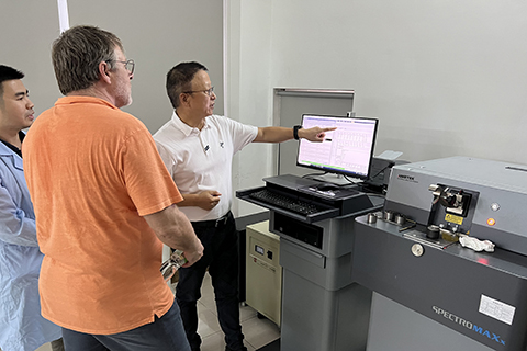 An instructor training 2 staff members in an engineering room