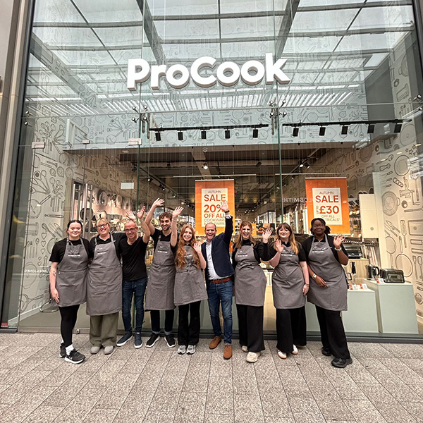 A staff photo outside a ProoCook store