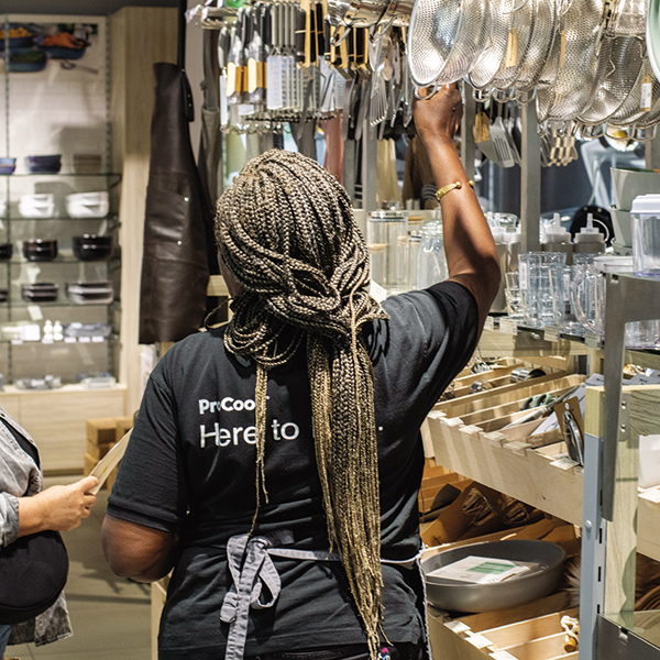 ProCook employee helping a customer pick out an item in store