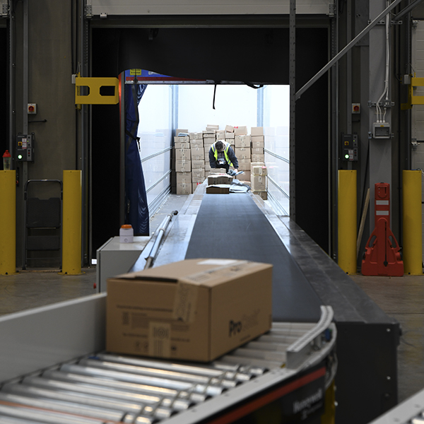 A cardboard box on a conveyor belt in a factory