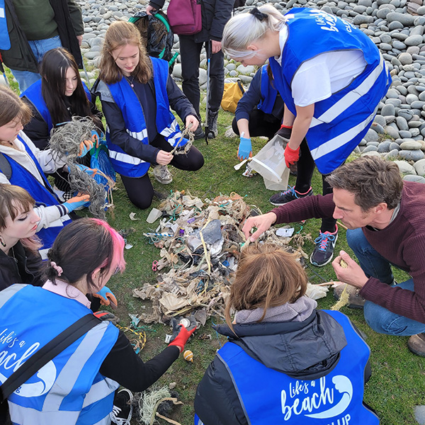 A group of volunteers cleaning litter from a beach